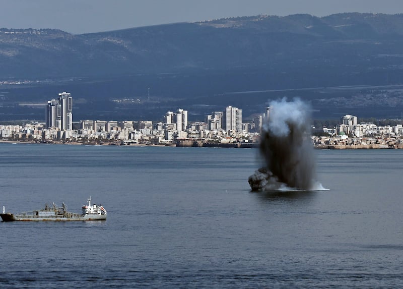 A plume of smoke rises as an Iranian missile hits the sea waters off Haifa, Israel on Saturday. Photograph: Atef Safadi/EPA