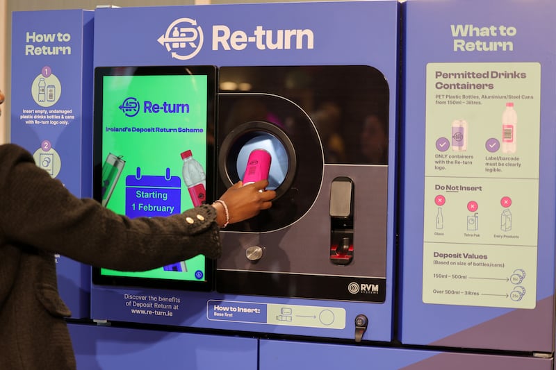 A shopper recycles a can at a Re-turn reverse vending machine. Photograph: Alan Betson

