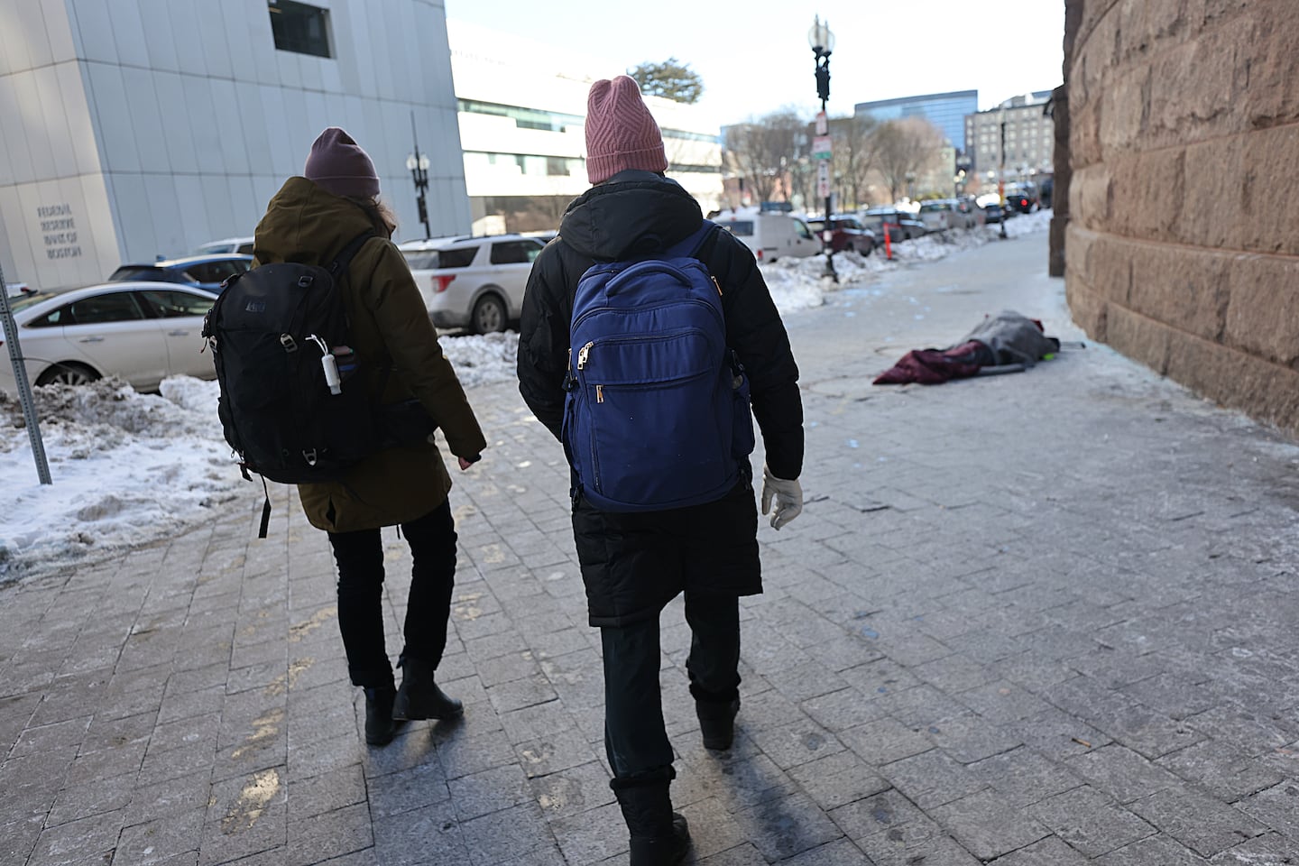Amy Summers (left) and Dr. Katherine Koh approached a person in a sleeping bag on the sidewalk on Jan. 29.