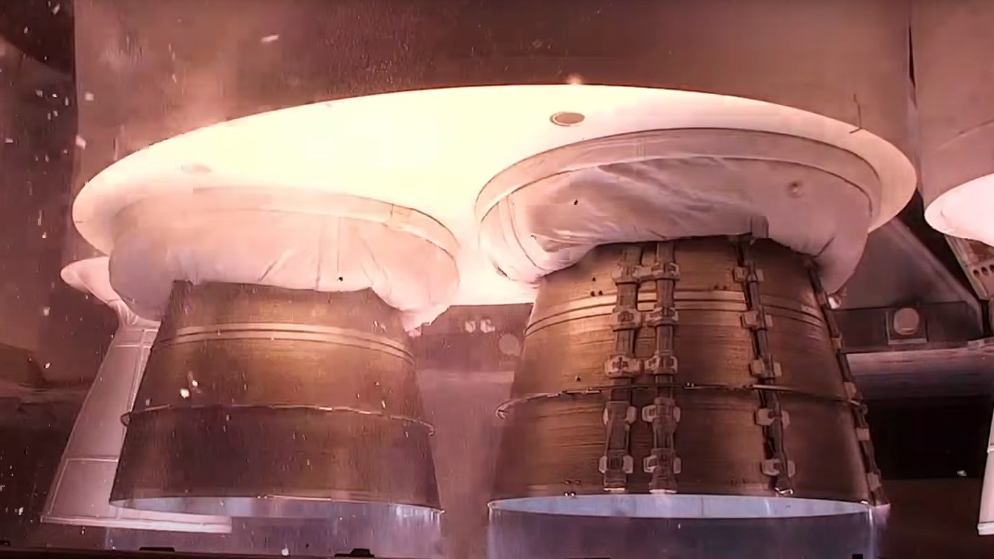 close up view of rocket shortly before liftoff with the engines ignited.