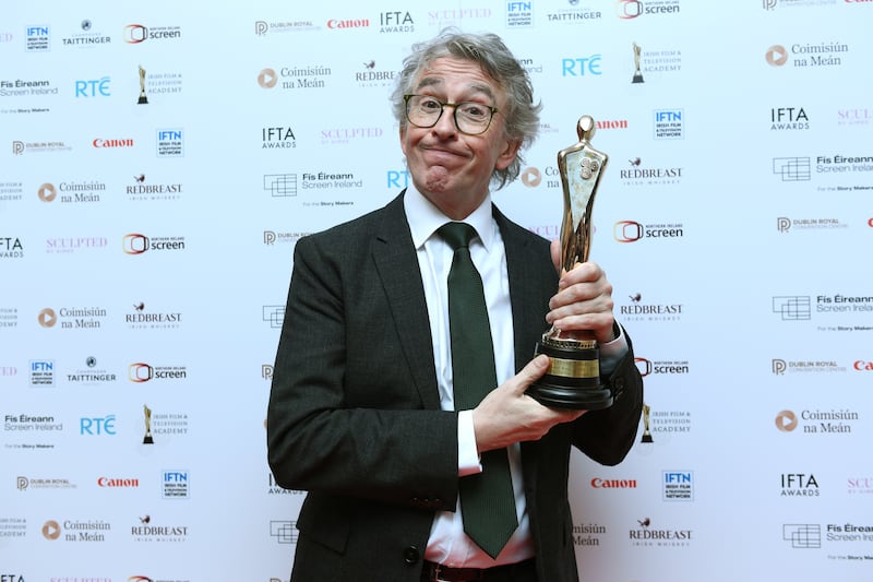 Steve Coogan accepts the best actor award on behalf of Saipan co-star Éanna Hardwicke at the awards. Photograph: Charles McQuillan/Getty