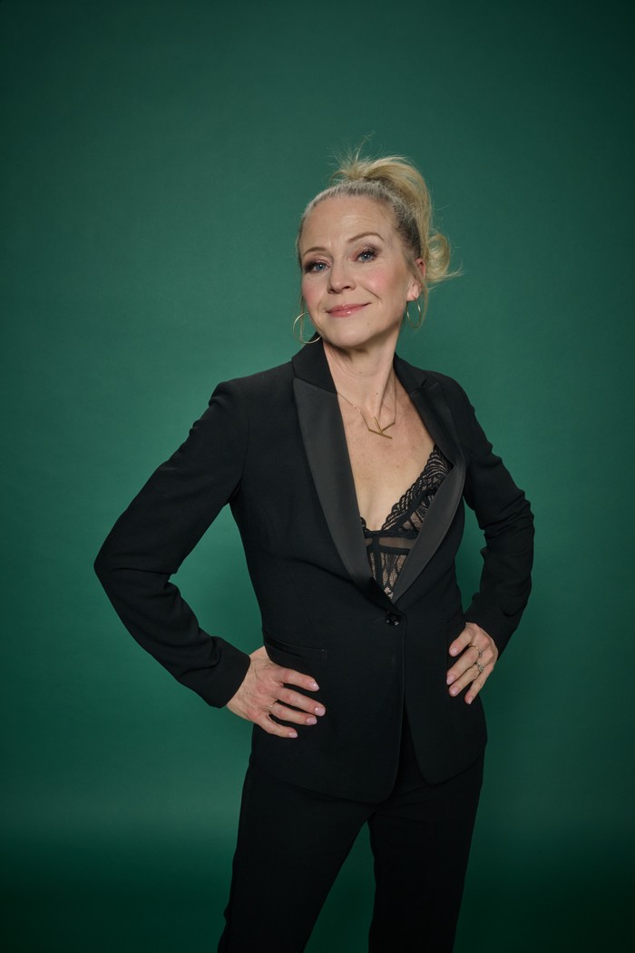Kellie Bright stands in a black suit against a green background for The Radio Times Covers Party 2026.