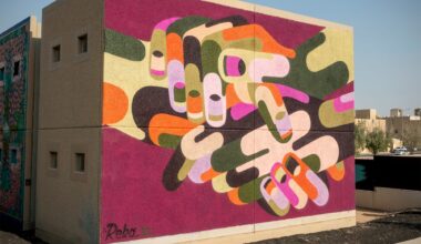 a vibrant abstracted mural of hands by James Reka