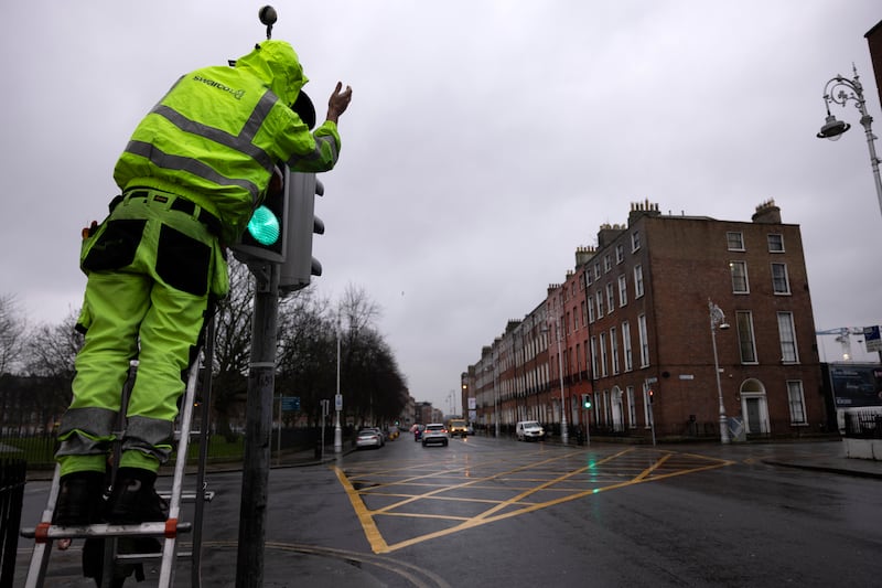 A broken traffic light is being fixed at Mountjoy Square as orange and yellow rain warnings are in place for several counties - with Met Éireann again warning of flooding. Photograph: Chris Maddaloni/The Irish Times 