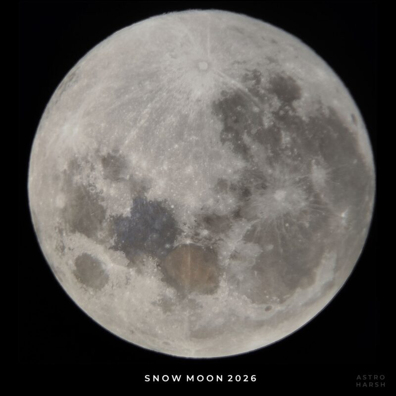 Closeup view of the gray, very cratered moon with some dark areas.