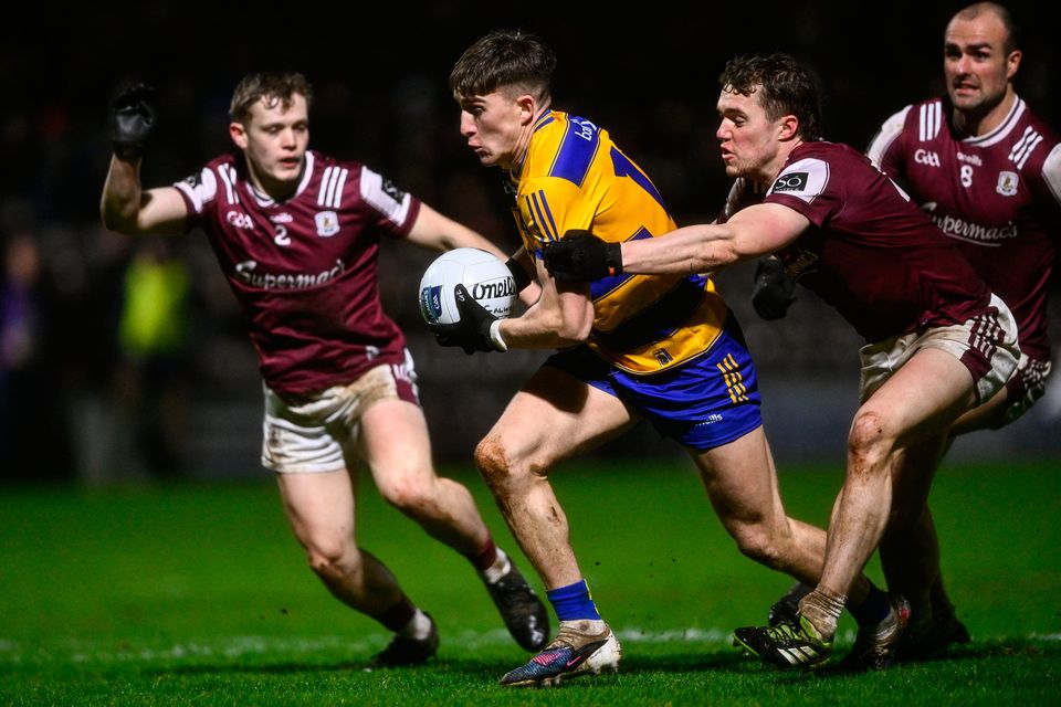 Roscommon's Daire Cregg is tackled by Jack Glynn, right, and Johnny McGrath of Galway during the Allianz NFL Division 1 clash at Pearse Stadium. Photo: Ben McShane/Sportsfile