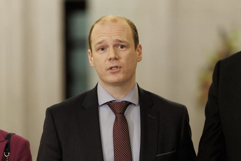 Communities Minister Gordon Lyons MLA speaking to the media in the Great Hall of Parliament Buildings at Stormont