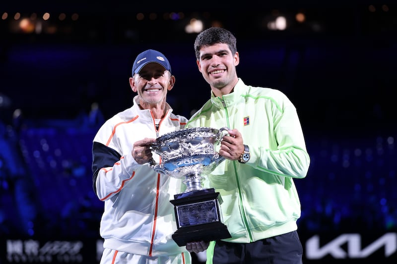 Carlos Alcaraz of Spain poses with his coach Samuel Lopez after his victory. Photograph: Clive Brunskill/Getty