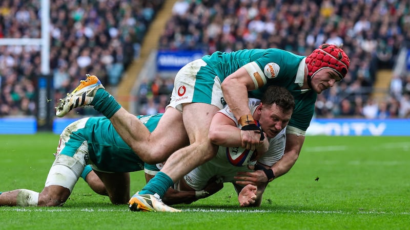 Ireland's Josh van der Flier and Robert Baloucoune tackle Fraser Dingwall as he scores England's first try. Photograph: Ben Brady/Inpho