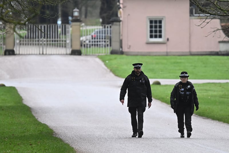 Police officers patrol near the gates of the Royal Lodge, Andrew Mountbatten-Windsor's former residence in Windsor on Thursday. Photograph: Leon Neal/Getty Images