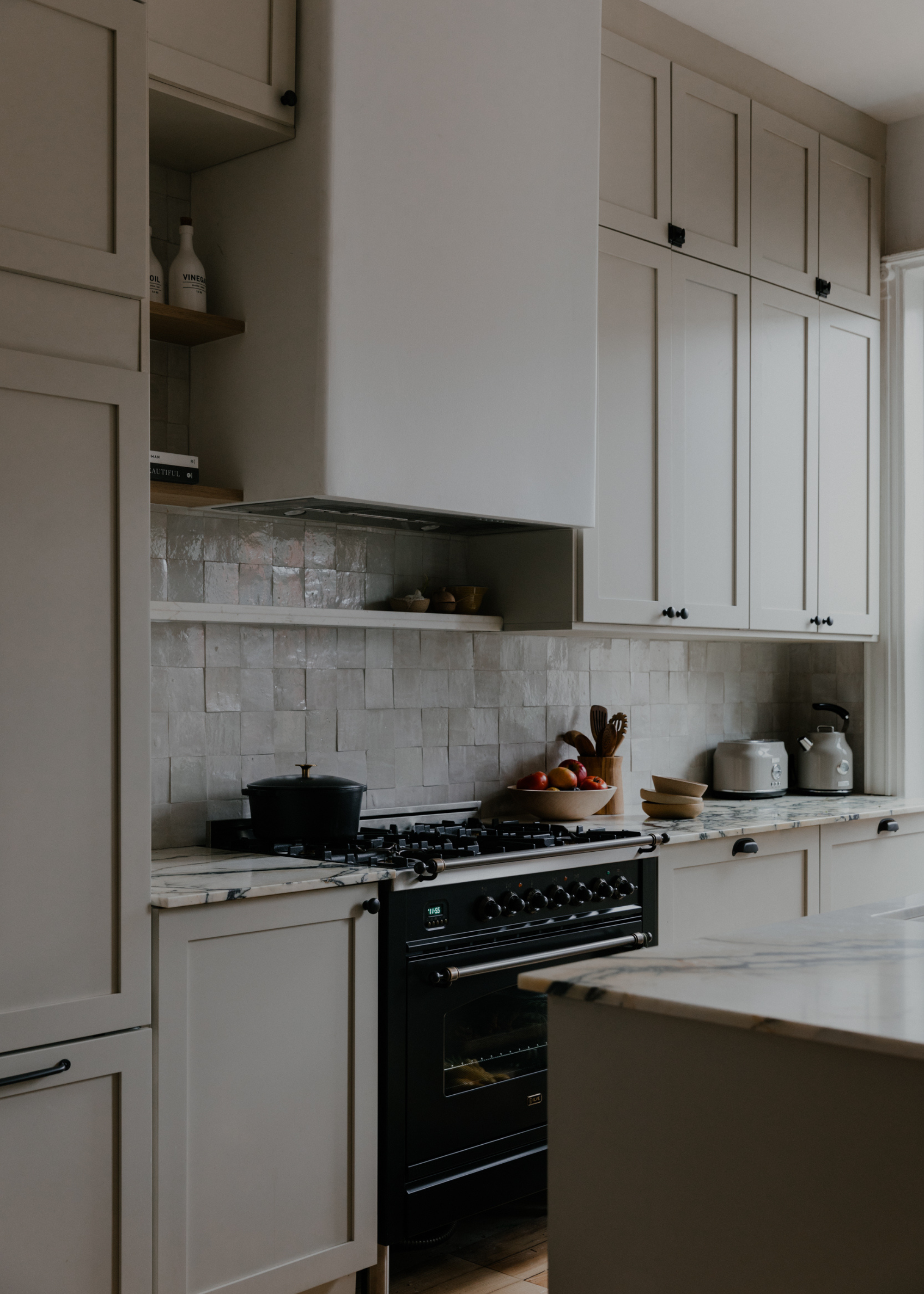light neutral kitchen with zellige tile backsplash and marble counters