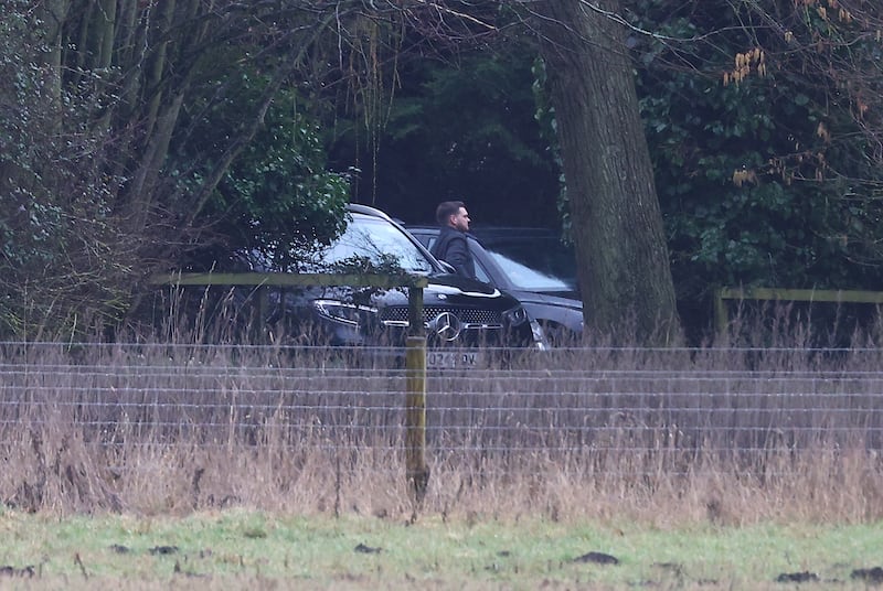 Men step out of an unmarked car at the home of Andrew Mountbatten-Windsor on Thursday. Photograph: Peter Nicholls/Getty Images