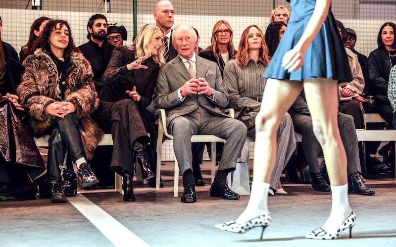 Charles sits between chief executive of the British Fashion Council Laura Weir (left) and designer Stella McCartney at the opening show of London Fashion Week on Thursday. Photograph: Richard Pohle/WPA Pool/Getty