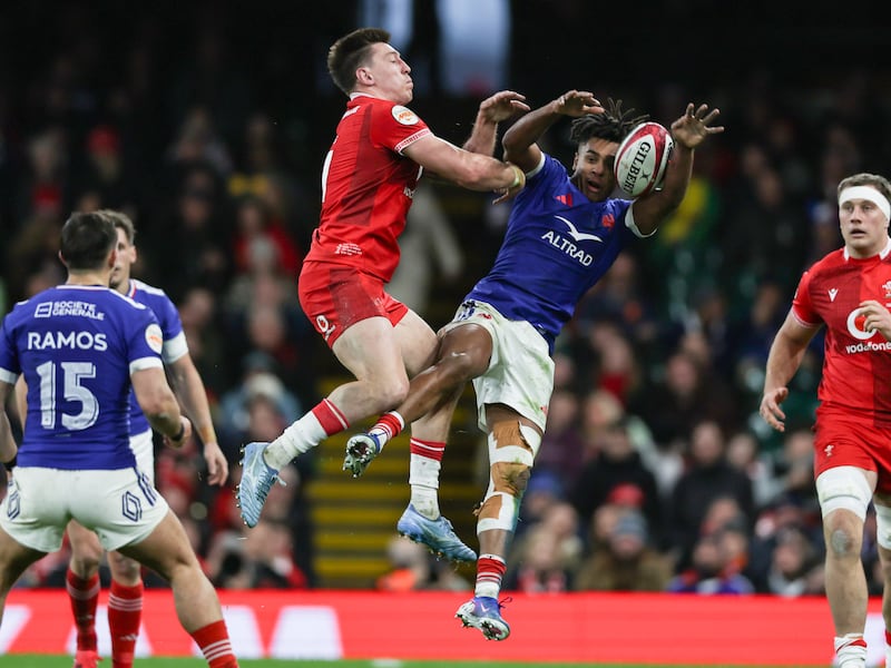 Wales' Josh Adams and France's Theo Attissogbe contest a high ball. Photograph: Billy Stickland/Inpho