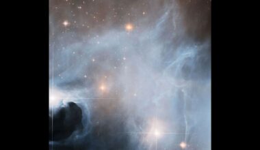 Photo numerous bright stars in space covered in think swirls of gray and white clouds.