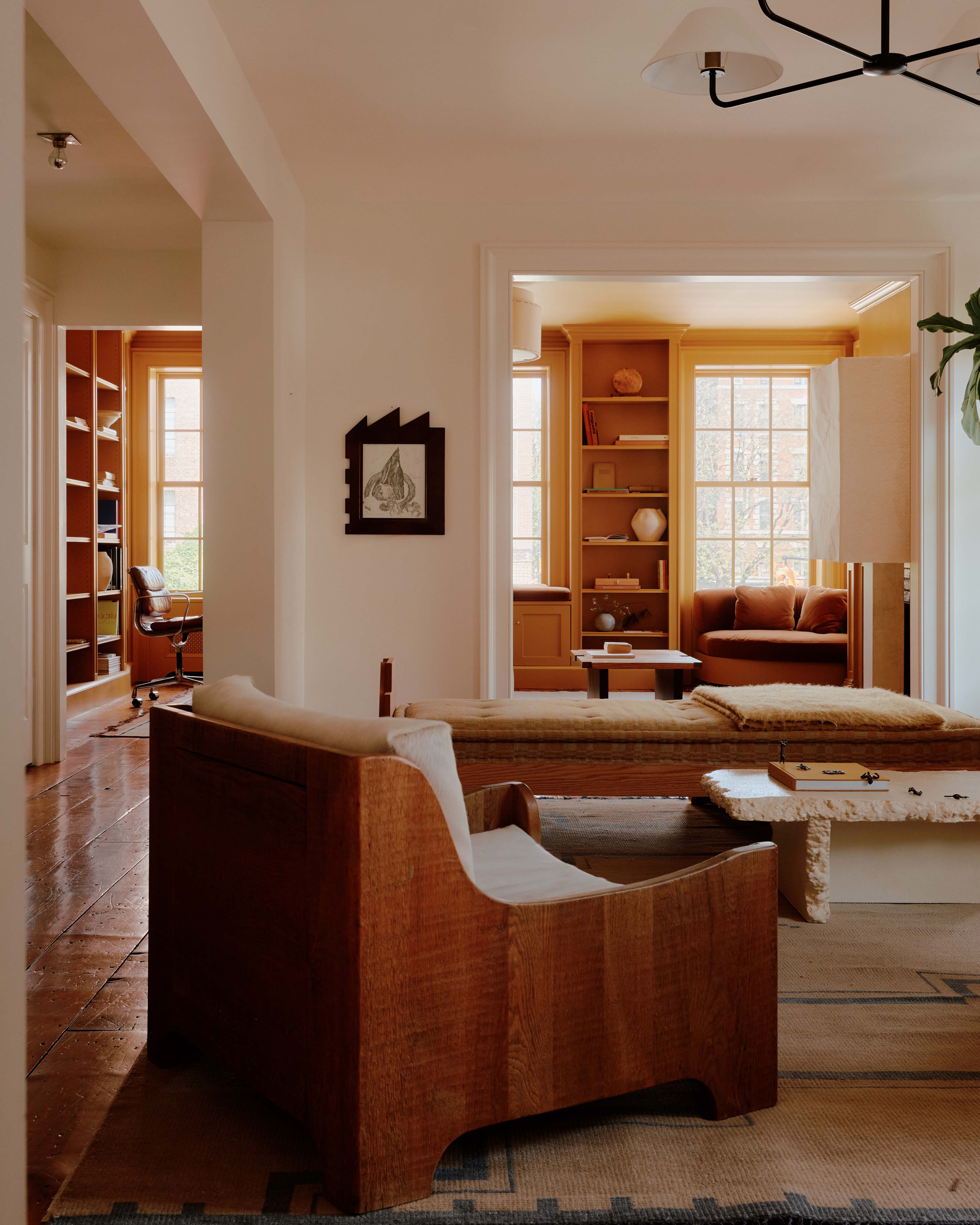 Modern interior featuring a wooden chair and light-filled rooms.