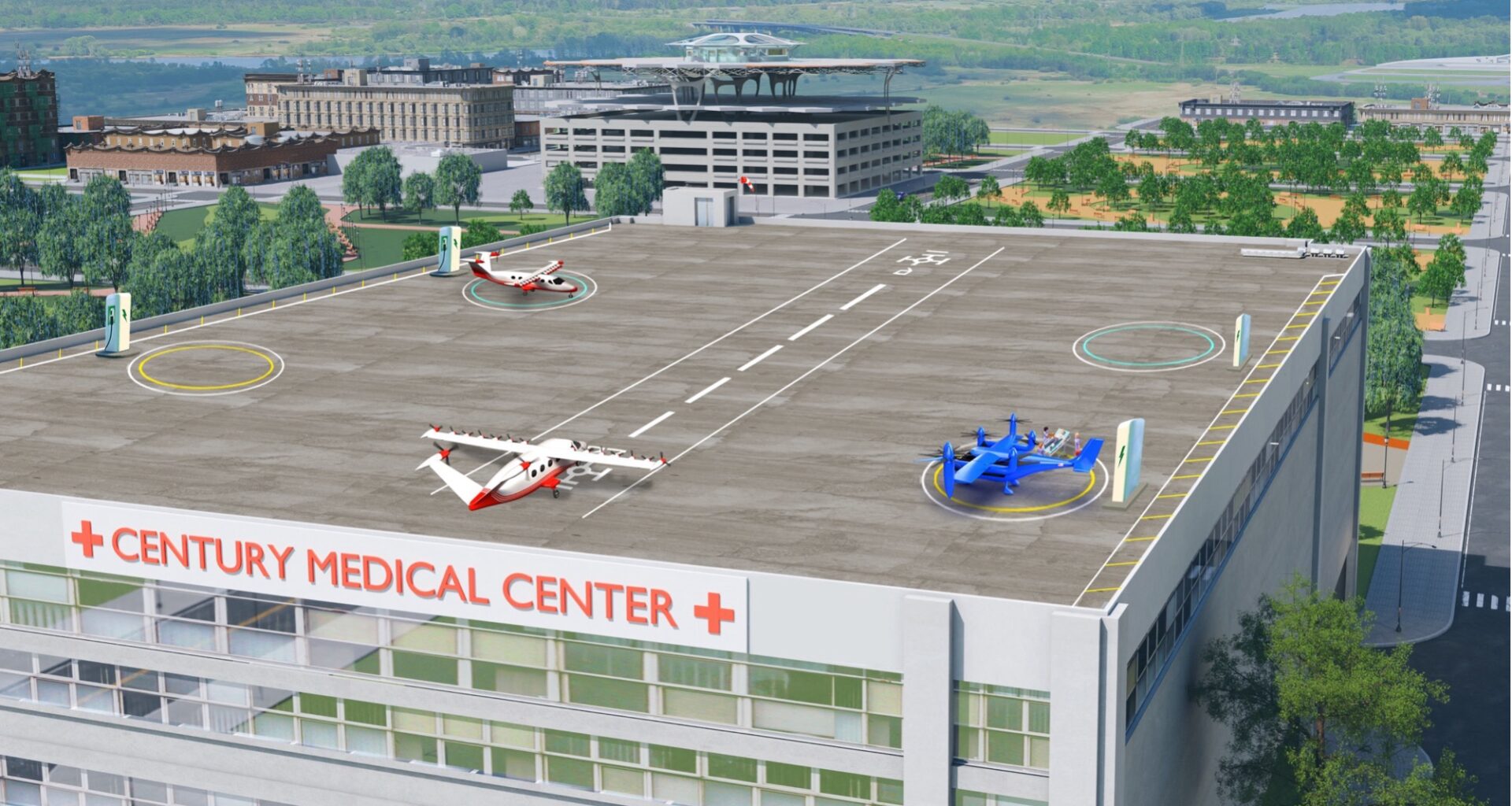 An artist’s concept image shows the square, gray rooftop of a hospital building with three concept aircraft sitting on top. One aircraft is painted dark blue, and two are painted with red and white paint schemes. Each aircraft has several unique propellors and wings to showcase that these aircraft can take off and land on short runways or vertically. The words “Century Medical Center” – in red – sit below the rooftop landing pad with several rows of windows underneath. In the background, there are several rows of trees, buildings, and parking garages, to show that this building is inside of a city.
