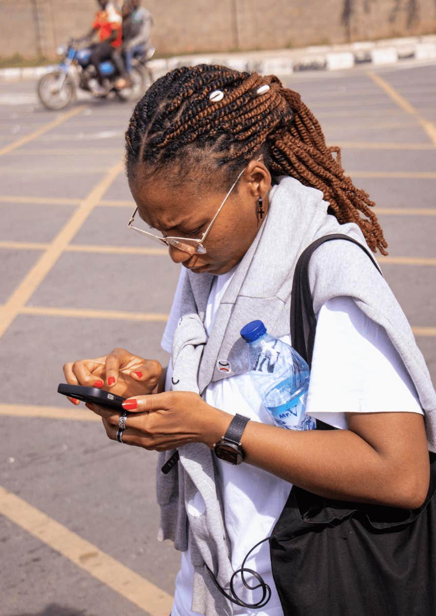 adult woman focused on her phone settings