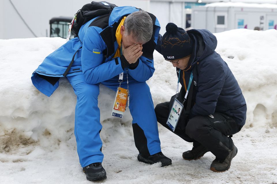 Mykhailo Heraskevych (l), the father of Ukraine's Vladyslav Heraskevych, reacts after his son was disqualified.