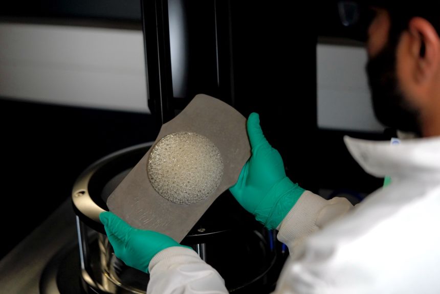 Biomedical engineer Ameya Narkar holds a breast tissue scaffold shortly after it came off a 3D printer.