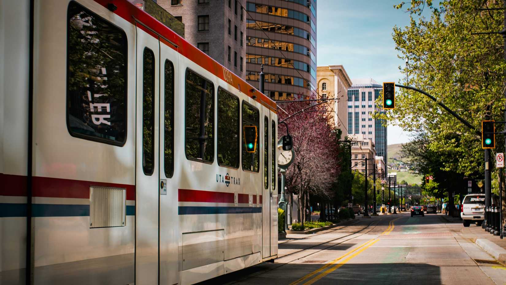 A photo of a Salt Lake City Tram at a green light on a sunny day