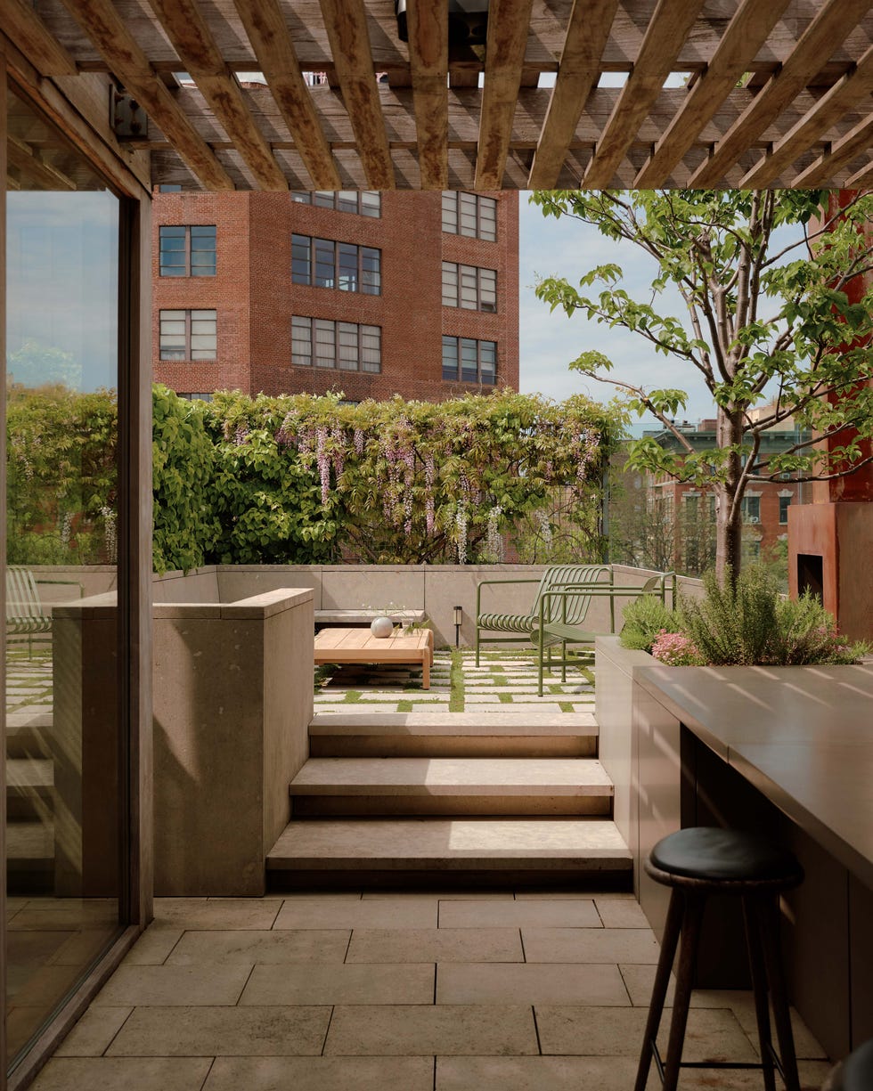 Urban terrace with a seating area and greenery.