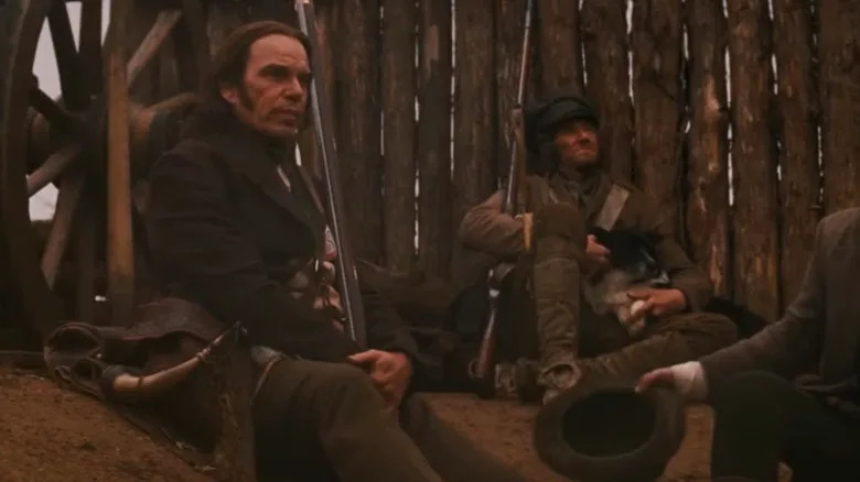 Billy Bob Thornton's Davy Crockett sits on the battlefield in The Alamo