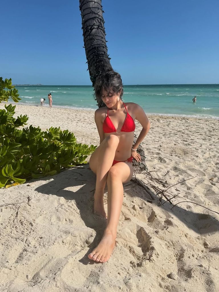 camila cabello sitting on beach red bikini