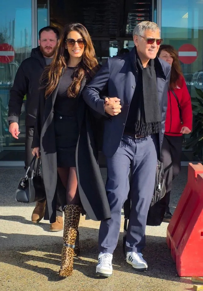 George and Amal Clooney arriving in Milan on Friday, February 6. Backgrid