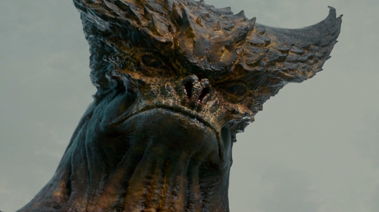 The kaiju looking down towards the ground in Colossal