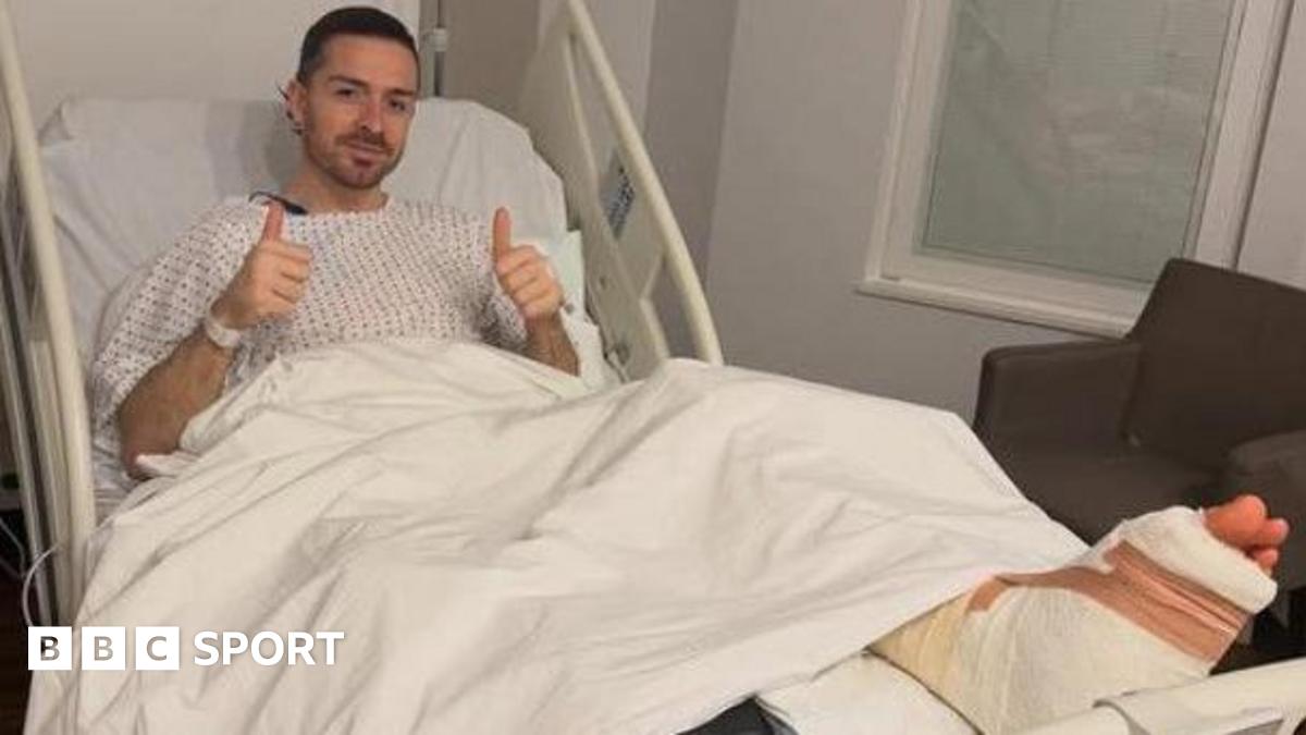 Midfielder Jack Grealish posing in a hospital bed with a bandaged foot