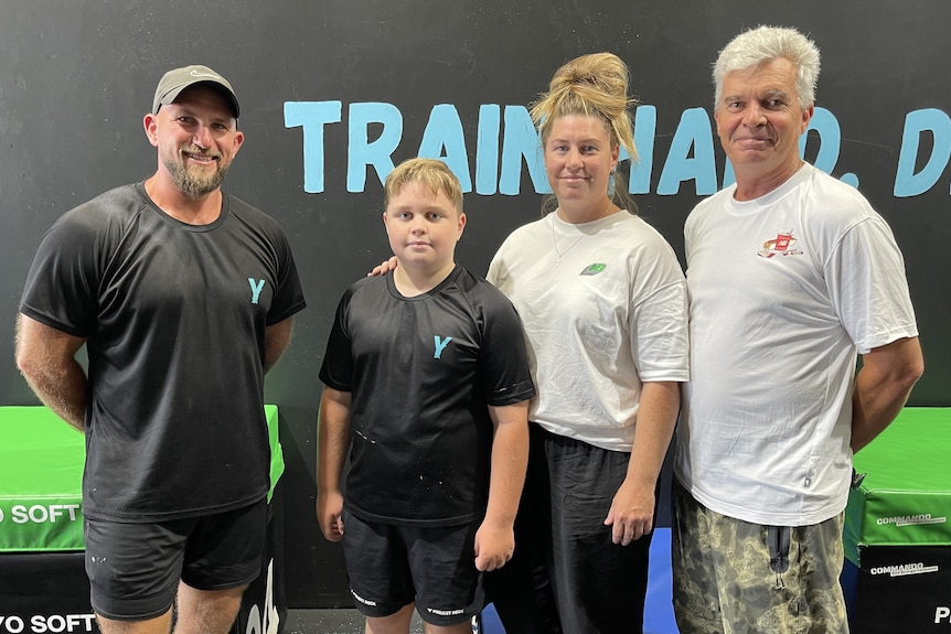 Jackson pictured with his mother (Cara Mackay) father (Brett Mackay) and coach (Joshua Hodges). 