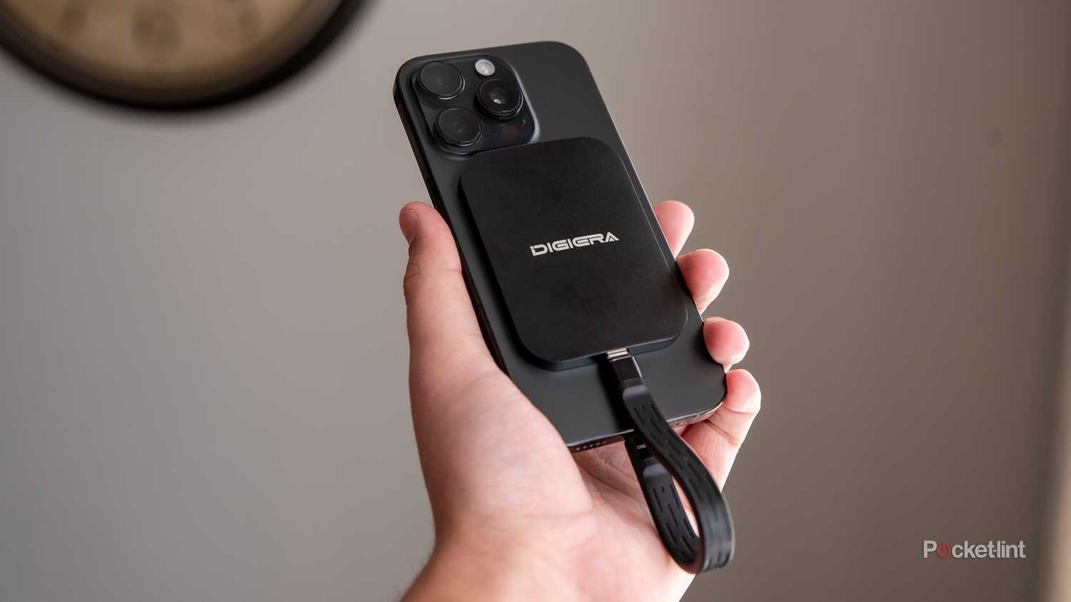 A still photo of the Digiera Endura SSD plugged into an iPhone 16 Pro in a hand. 