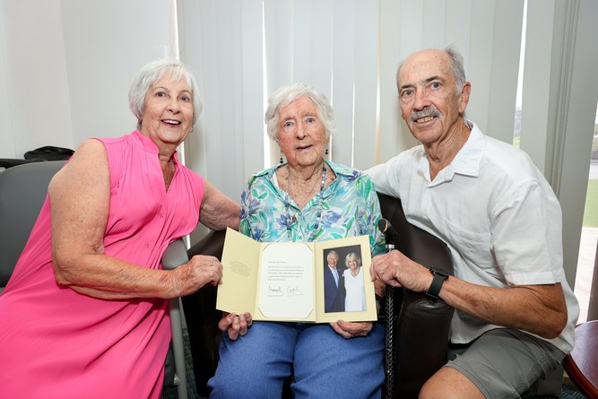 Elsie Cotton pictured with daughter Marilyn Browne, son Geoff Cotton, and her 100th birthday card from King Charles and Queen Camilla.