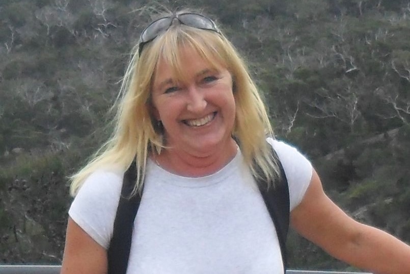 Dr Coral Rowston stands with a backpack on.