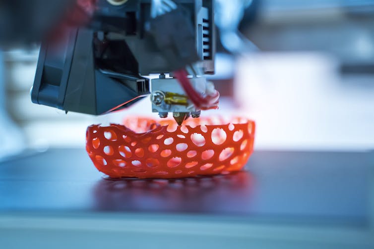 A 3D printer printing out an object filled with holes.