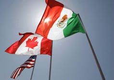 flags of Mexico, Canada and the U.S. on poles