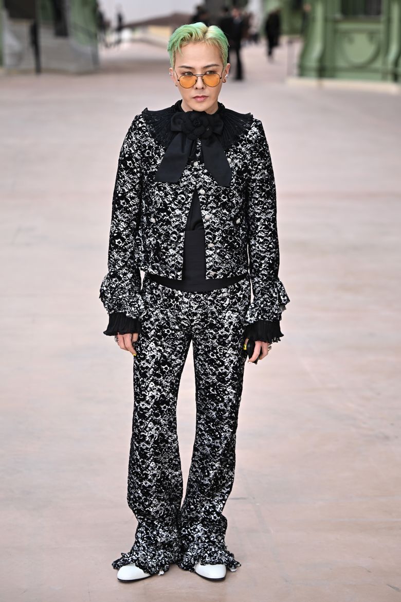 G-Dragon of Big Bang is known for breaking gender norms by effortlessly incorporating women's clothing and accessories into his wardrobe. He is pictured attending Chanel's couture Spring-Summer 2025 show last January.