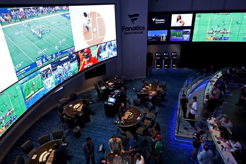 People watch NFL football in a Fanatics Sportsbook in Atlantic City, New Jersey, in September.