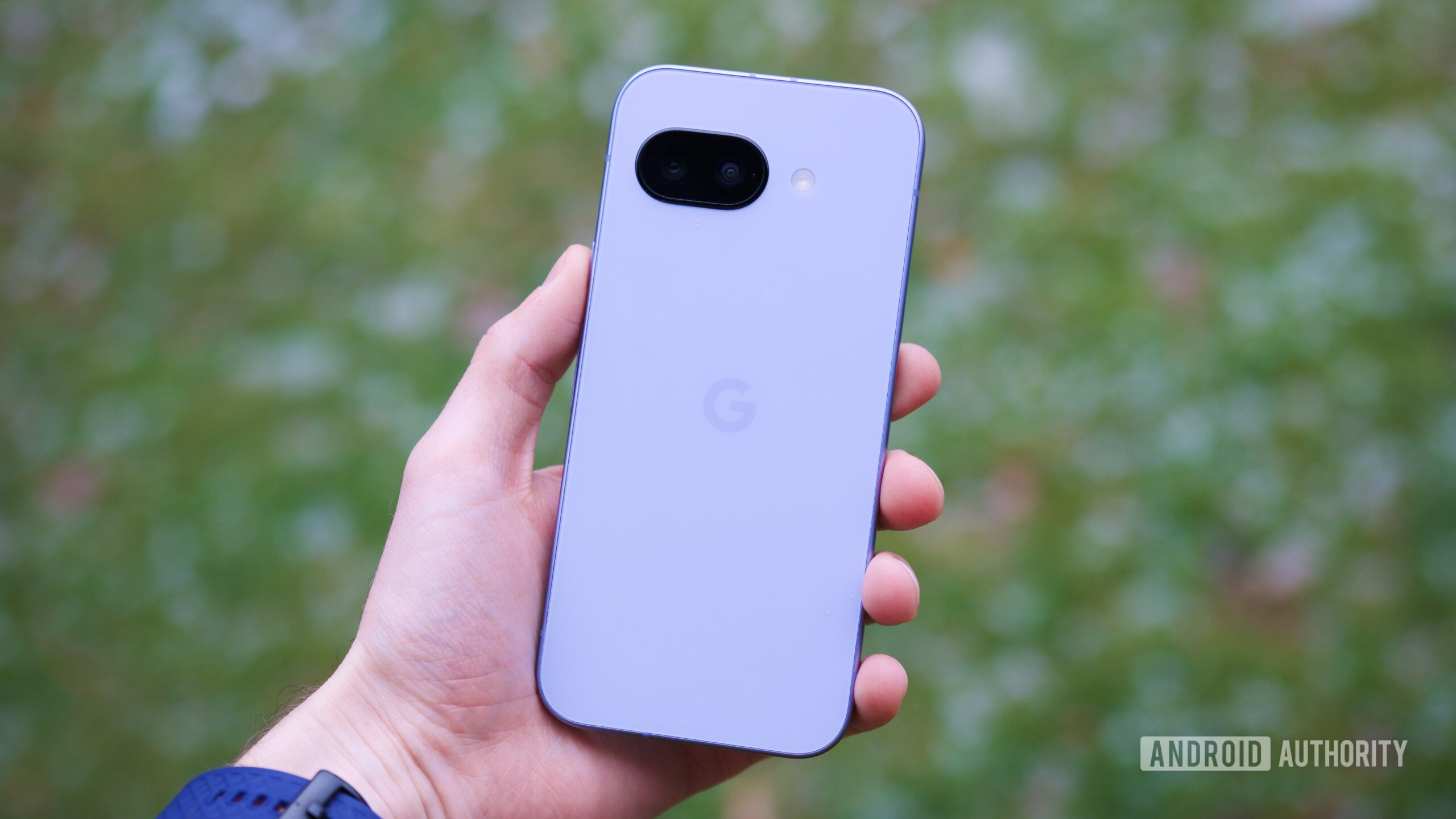 Someone holding the Pixel 9a, showing the back of the phone.