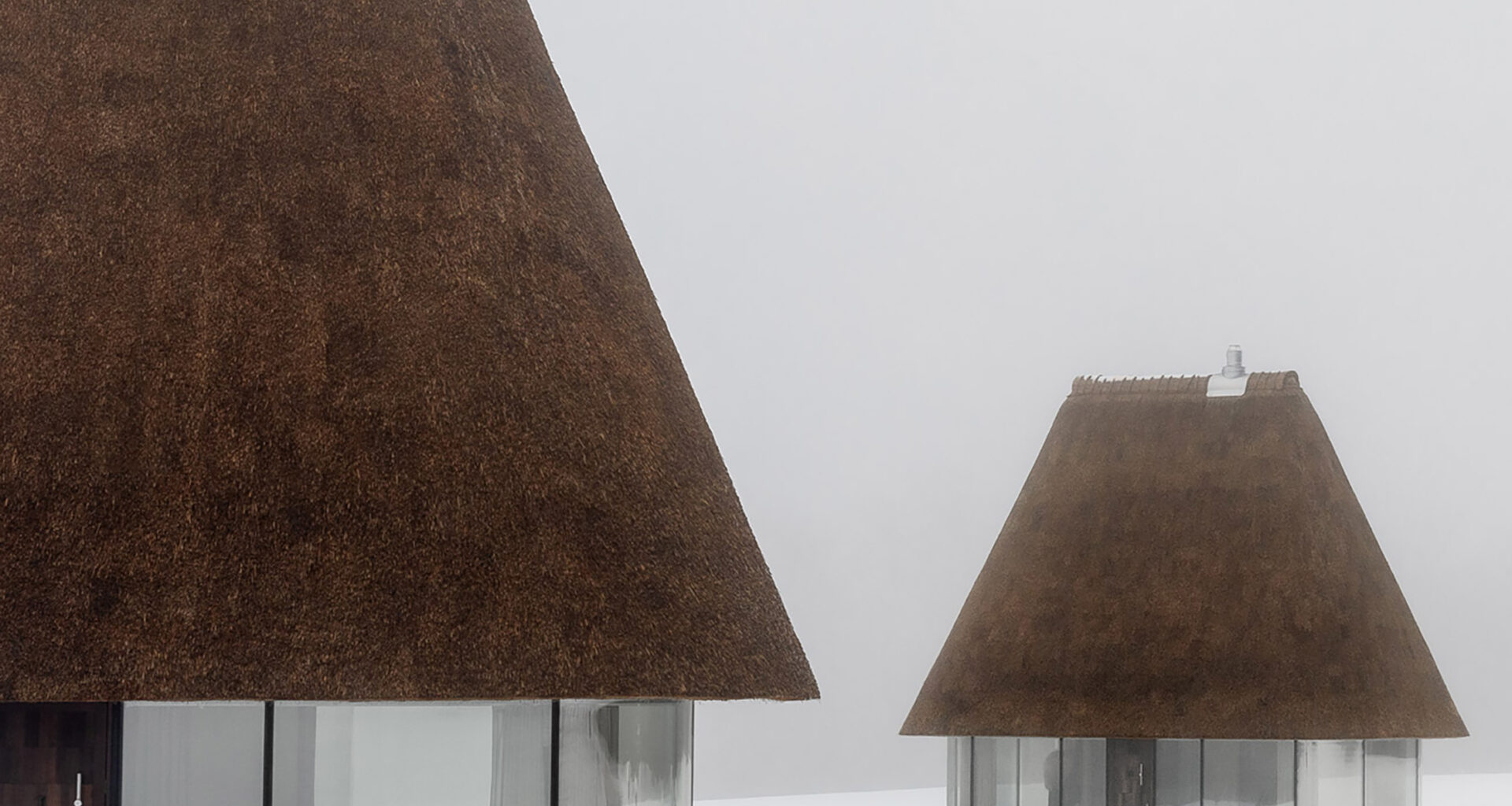 YOD Group crowns glass huts with 10-metre-tall thatched roofs