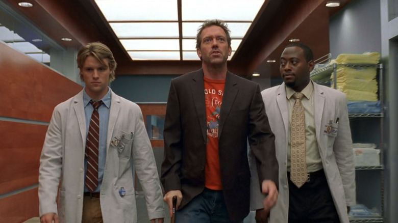 Dr. Robert Chase, Gregory House, and Dr. Eric Foreman walk down a hospital corridor on House (2004-2012)