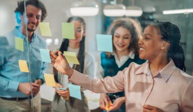 Businesswoman writing on sticky notes during a brainstorming session