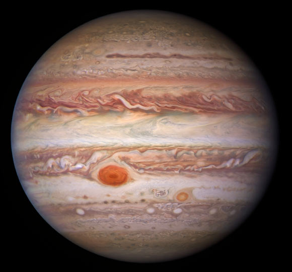 This visible-light image of Jupiter was created from data captured on January 11, 2017 using Hubble’s Wide Field Camera 3. Near the top, a long brown feature called a ‘brown barge’ extends 72,000 km (nearly 45,000 miles) in the east-west direction. The Great Red Spot stands out prominently in the lower left, while the smaller feature nicknamed Red Spot Jr. (known to Jovian scientists as Oval BA) appears to its lower right. Image credit: NASA / ESA / NOIRLab / NSF / AURA / Wong et al. / de Pater et al. / M. Zamani.