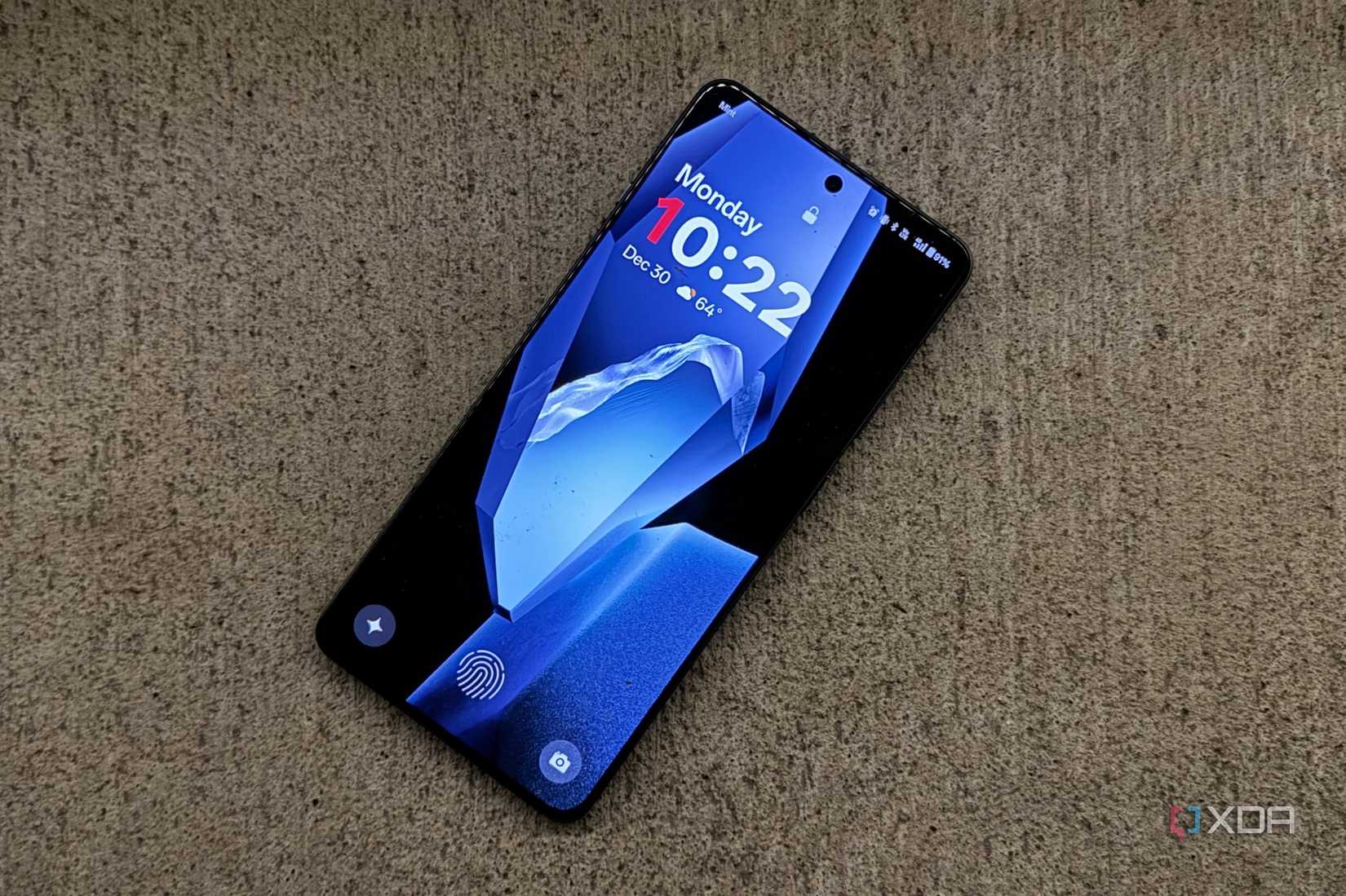 The OnePlus 13R lying flat on a marble counter