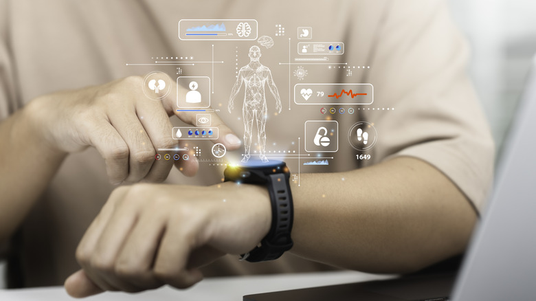 An individual pointing at a smartwatch attached to their wrist, above the watch is imagery of health metrics for an individual