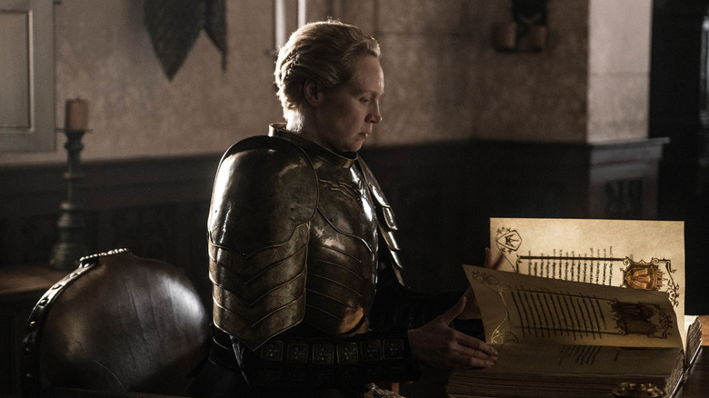 Gwendoline Christie's Brienne of Tarth sitting and reading a book on Game of Thrones