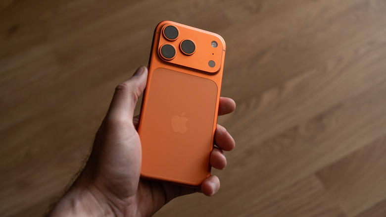 An iPhone 17 Pro, in a man's hand.