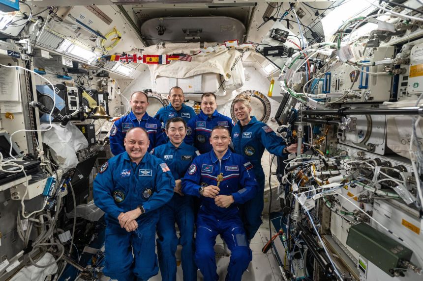 The Expedition 74 crew gathers for a portrait aboard the International Space Station in January 2025, when NASA astronaut Mike Fincke (front left) handed over command of the orbital outpost to Roscosmos cosmonaut Sergey Kud-Sverchkov (front right).