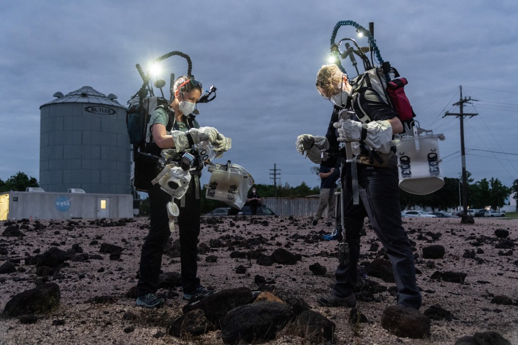 Test subjects Kelsey Young and Tess Caswell evaluate lunar field geology tasks as part of the Exploration Extravehicular Activity (xEVA) night operations development tests conducted at Johnson Space Center’s Rock Yard. (NASA/Noah Moran)